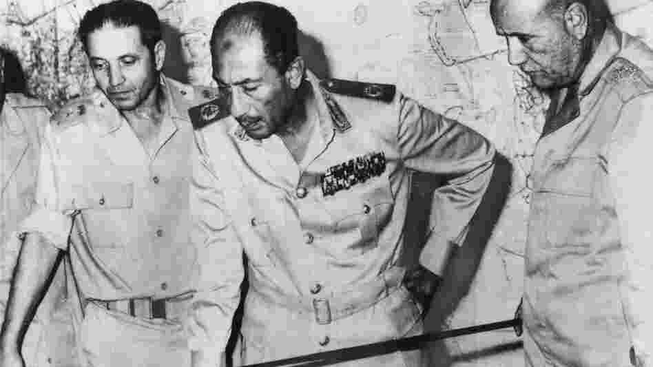 Egyptian President Anwar Sadat is flanked by senior military officers as he reviews maps of battlefield developments in the 1973 Arab-Israeli War. He's shown at army headquarters in Cairo on Oct. 15, 1973. Egypt and Syria attacked Israel, catching Israel and the CIA off-guard.