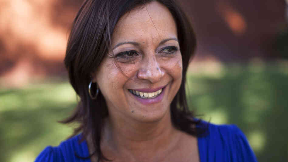 Arlene Bonet settled in Orlando, Fla., after her Puerto Rico real estate business crashed. She's now working for a Puerto Rican cultural organization in Orlando, while her son and mother still live in her hometown, Cabo Rojo, Puerto Rico.