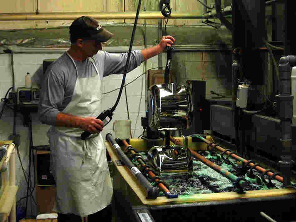 Craig McCarl dips Xlerator covers two at a time into a chrome bath. He has worked for Excel Dryer in East Longmeadow, Mass., for 31 years.
