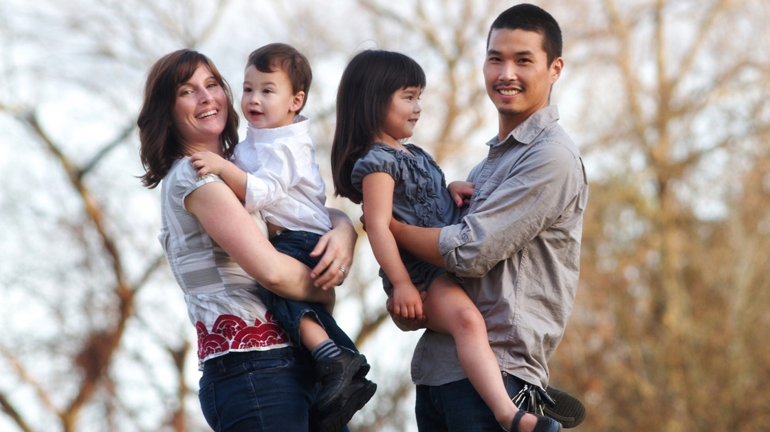 Jeannine Sato holds her 2-year-old son, Keni; 5-year-old Hana is held by her father, Mas Sato. Jeannine decided to leave her job when her employers said she could take six weeks off after giving birth to her first child or risk losing her job.