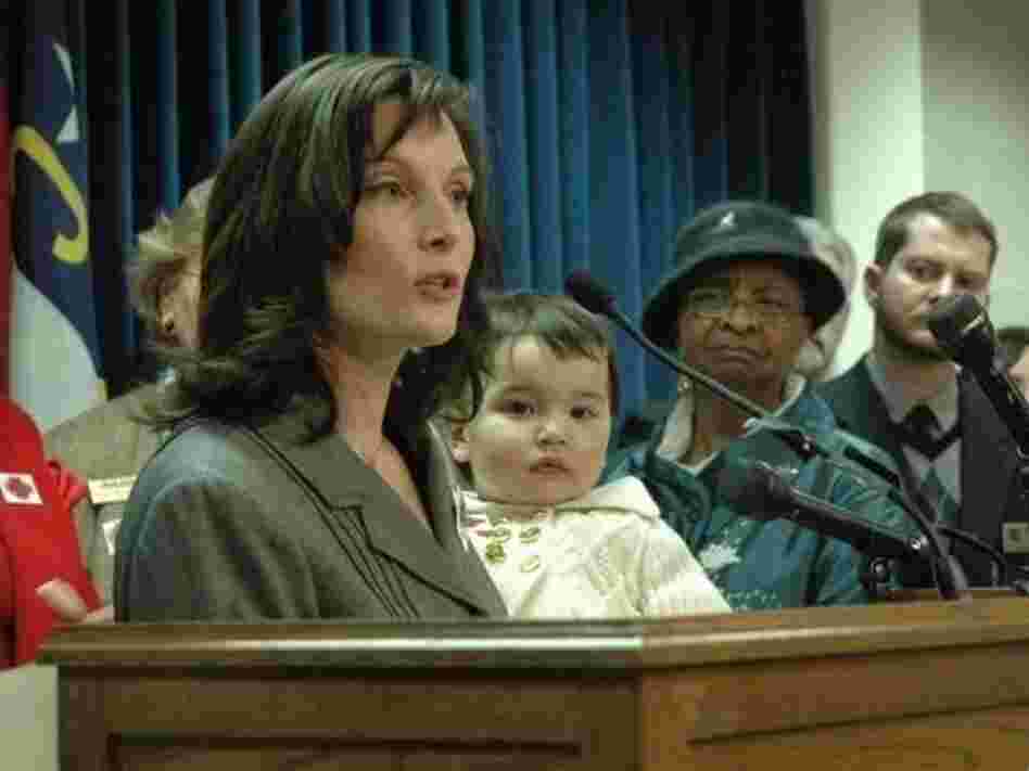 Sato holds Hana as she speaks during a 2009 press conference at the North Carolina state Legislature about the need for paid sick days.
