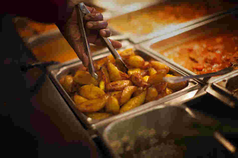 A worker prepares plantains at Pioco's Chicken.