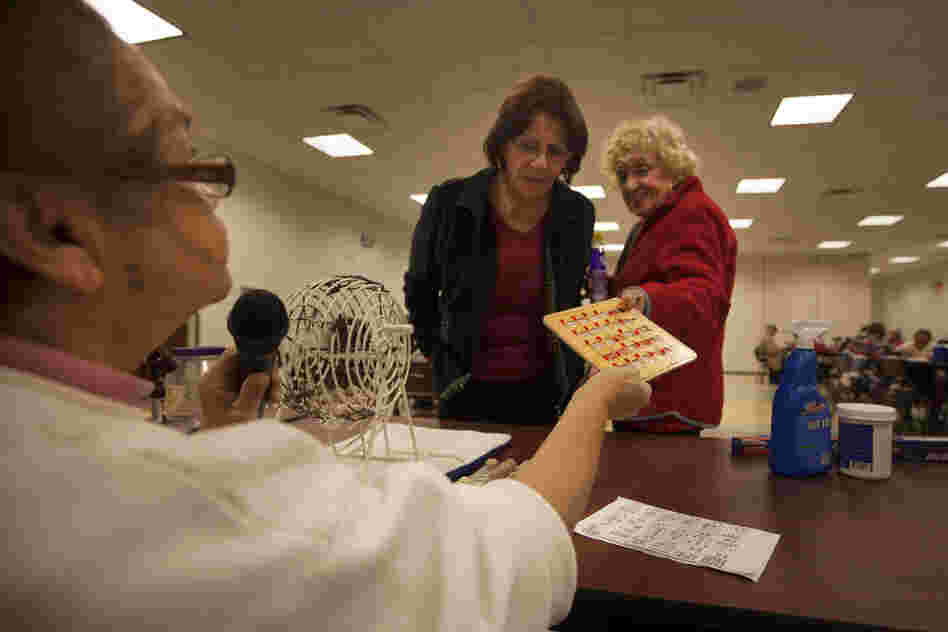 Bingo caller Zinnia Rosado of St. Cloud, Fla., checks a winning bingo card at the Robert Guevara Community Center.