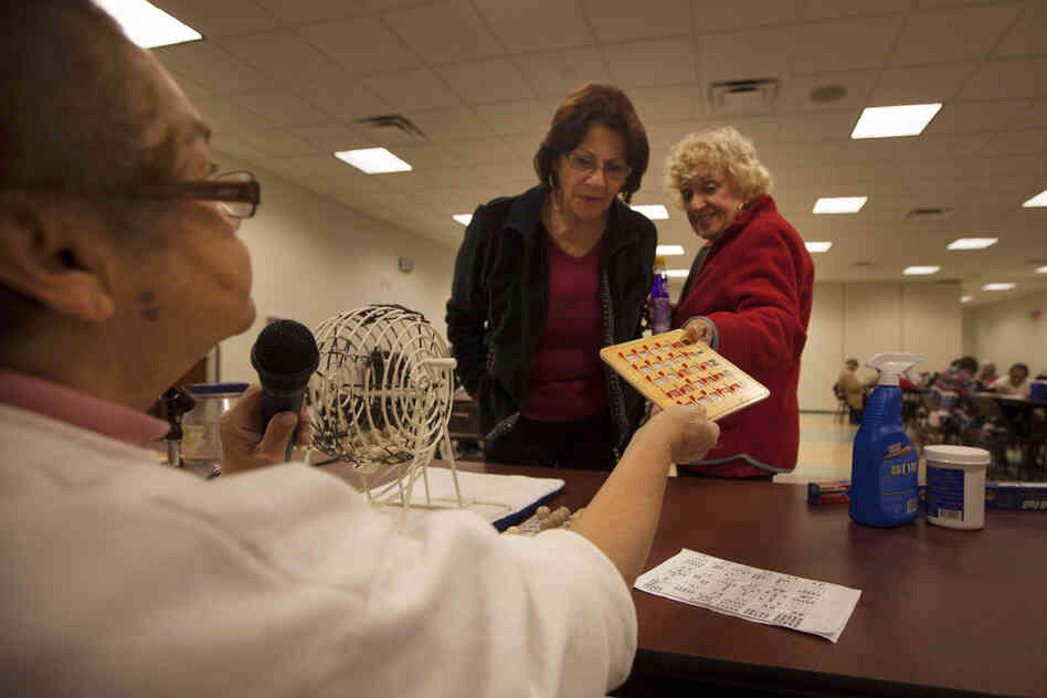 Bingo caller Zinnia Rosado of St. Cloud, Fla., checks a winning bingo card at the Robert Guevara Community Center.