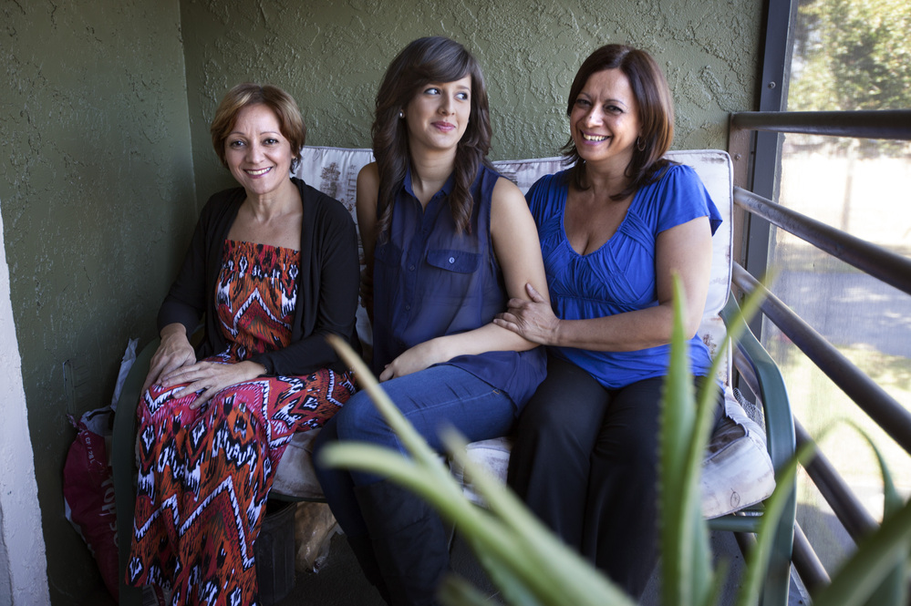 Arlene Bonet (right), shown with her daughter, Didra, and her sister Genoveva (left), lives in Orlando, Fla. Bonet's daughter, who works part time and attends college part time, lives with her.