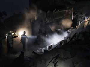 Syrians look for survivors amid the rubble of a building targeted by a missile in the al-Mashhad neighborhood of Aleppo on Jan. 7.