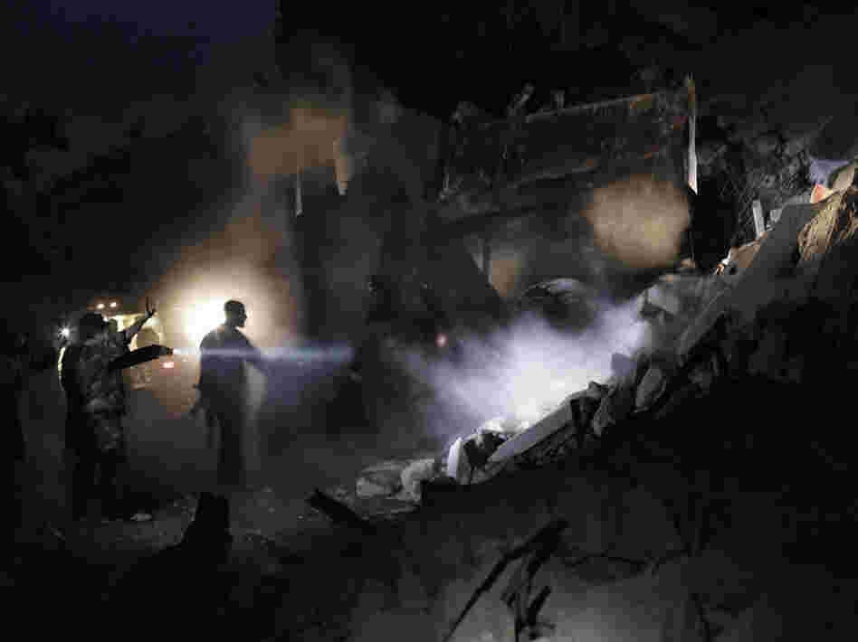 Syrians look for survivors amid the rubble of a building targeted by a missile in the al-Mashhad neighborhood of Aleppo on Jan. 7.