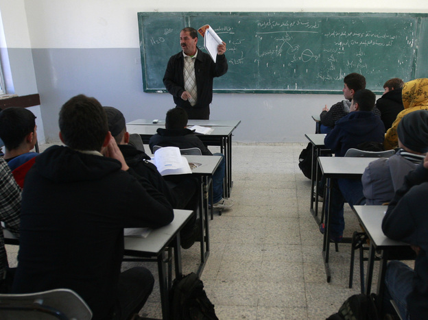 Palestinian students attend a class in the West Bank city of Ramallah on Sunday.