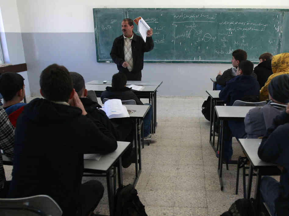 Palestinian students attend a class in the West Bank city of Ramallah on Sunday.