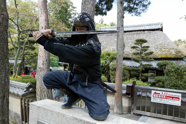 An authentic master of ninjutsu martial art, Kazuki Ukita poses in Ninja costume at the Ninja museum's Ninja residence in the small ancient city of Ueno.