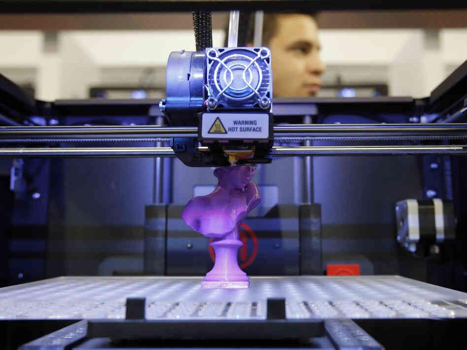 A 3-D desktop printer on display at the 2013 International Consumer Electronics Show in Las Vegas demonstrates how designs are translated into plastic objects.