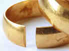 Image of a wedding ring, with part of it missing.