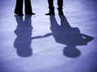 A businesswoman and businessman shake hands.