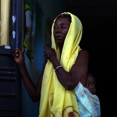 A woman and her child wait to see health workers at a clinic in northern Nigeria, where Doctors Without Borders is treating children with severe lead poisoning.