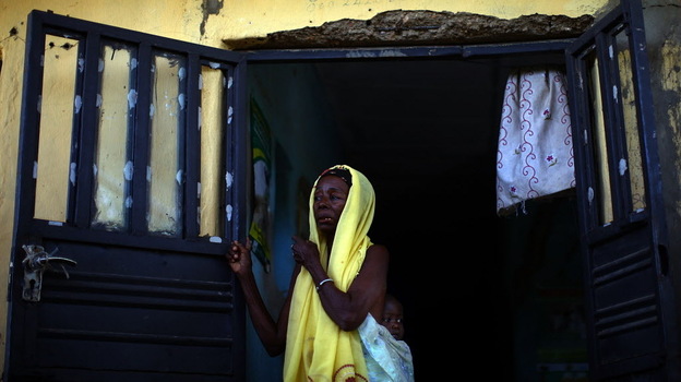 A woman and her child wait to see health workers at a clinic in northern Nigeria, where Doctors Without Borders is treating children with severe lead poisoning.