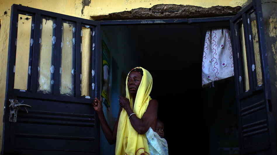 A woman and her child wait to see health workers at a clinic in northern Nigeria, where Doctors Without Borders is treating children with severe lead poisoning.