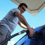 Raul Rivero fills up in Miami. Having less take-home pay at the same time gas prices are rising could dampen consumer spending, economists say. Raul Rivero fills up in Miami. Having less take-home pay at the same time gas prices are rising could dampen consumer spending, economists say.