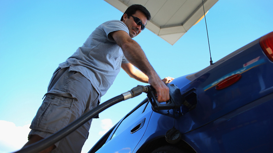 Raul Rivero fills up in Miami. Having less take-home pay at the same time gas prices are rising could dampen consumer spending, economists say.