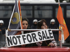 Employees of Hellenic Postbank protest during a strike against the bank's privatization in Athens, in December. Employees of Hellenic Postbank protest during a strike against the bank's privatization in Athens, in December.