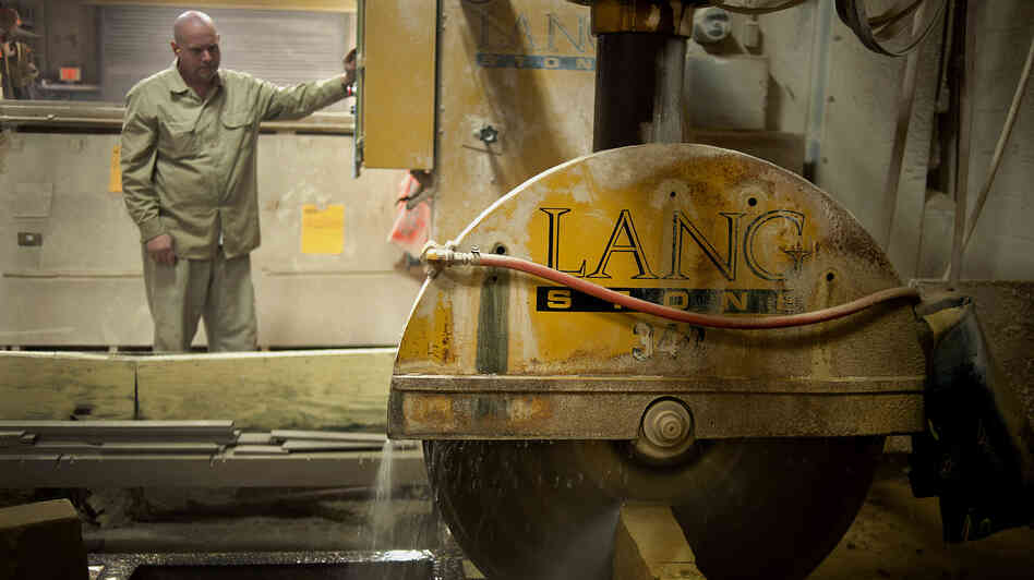 An employee uses a wet saw to cut a slab of sandstone at a Lang Stone Co. facility in Columbus, Ohio, in January. Using water while cutting helps keep dust out of the air. An employee uses a wet saw to cut a slab of sandstone at a Lang Stone Co. facility in Columbus, Ohio, in January. Using water while cutting helps keep dust out of the air.