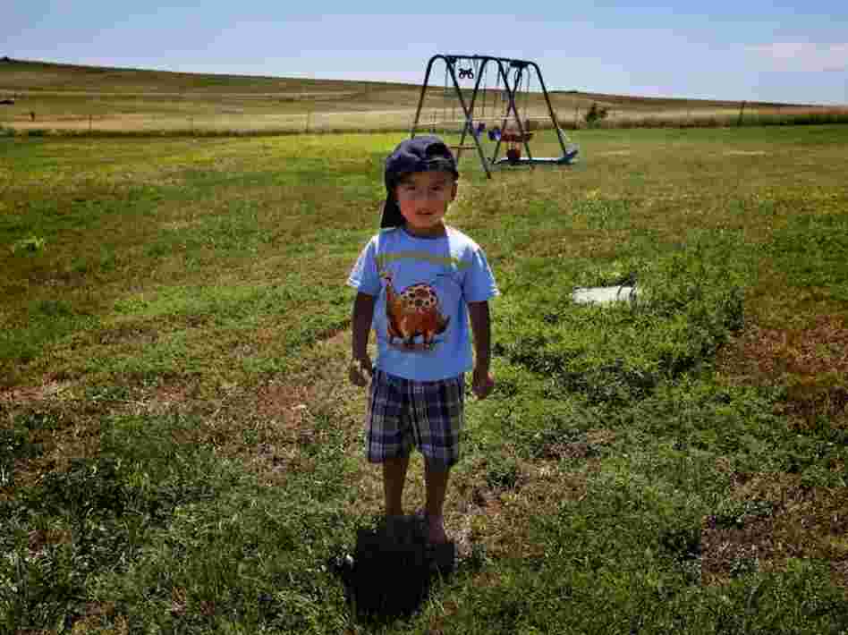 Derrin Yellow Robe, 3, stands in his great-grandparents' backyard on the Crow Creek Reservation in South Dakota. He was taken off the reservation by South Dakota's Department of Social Services in July 2009 and spent a year and a half in foster care before being returned to his family.
