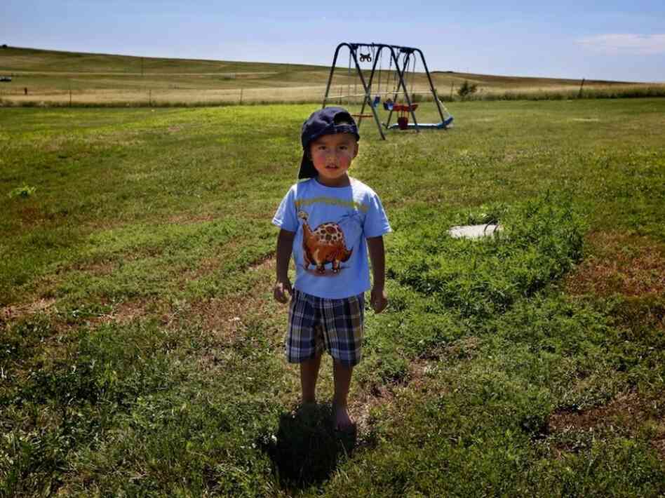 Derrin Yellow Robe, 3, stands in his great-grandparents' backyard on the Crow Creek Reservation in South Dakota. He was taken off the reservation by South Dakota's Department of Social Services in July 2009 and spent a year and a half in foster care before being returned to his family.