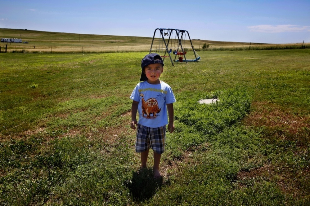 Derrin Yellow Robe, 3, stands in his great-grandparents' backyard on the Crow Creek Reservation in South Dakota. He was taken off the reservation by South Dakota's Department of Social Services in July 2009 and spent a year and a half in foster care before being returned to his family.