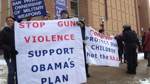 Supporters of gun control laws await President Obama's appearance Monday outside the Minneapolis Police Department's Special Operations Center.