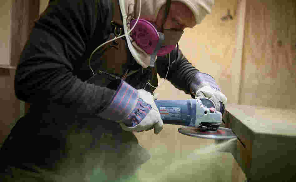 A worker makes a cut in the side of a sandstone block at the Cleveland Quarries facility in Vermilion, Ohio, earlier this month. The legal limit on the amount of silica that workers can inhale was set decades ago.