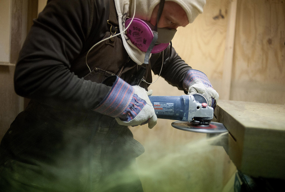 A worker makes a cut in the side of a sandstone block at the Cleveland Quarries facility in Vermilion, Ohio, earlier this month. The legal limit on the amount of silica that workers can inhale was set decades ago.