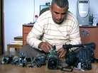 Co-director Emad Burnat examines his five broken cameras. Co-director Emad Burnat examines his five broken cameras.