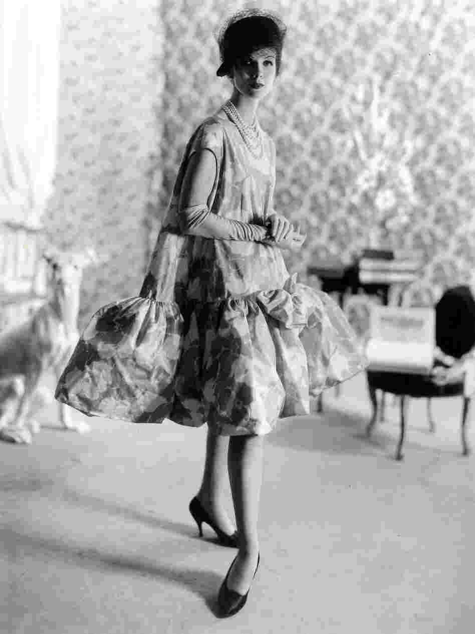 Balenciaga debuted his baby doll dress in 1958. Blume writes, "all women benefited — and benefit still — from the principal achievement of [Balenciaga's] 1950s lines: the elimination of a tight nipped-in waist and the smoother, more yielding silhouette."
