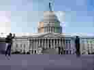 Tourists take photographs in front of the U.S. Capitol on Jan. 2, the day after Congress passed a bill to avoid the fiscal cliff.