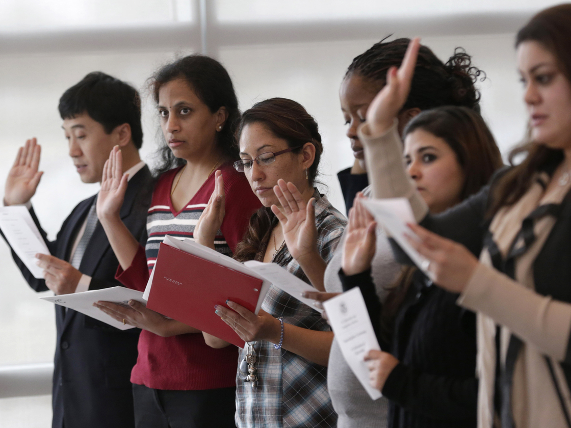 Immigrants take the U.S. oath of citizenship during a naturalization ceremony in Irving, Texas.