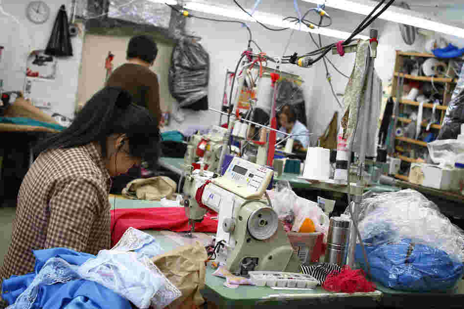 A seamstress works on a garment in the factory Yee contracts to produce her line. While the final product of high-end fashion is crisp and clean, the beginning stages can easily be described as creative chaos.