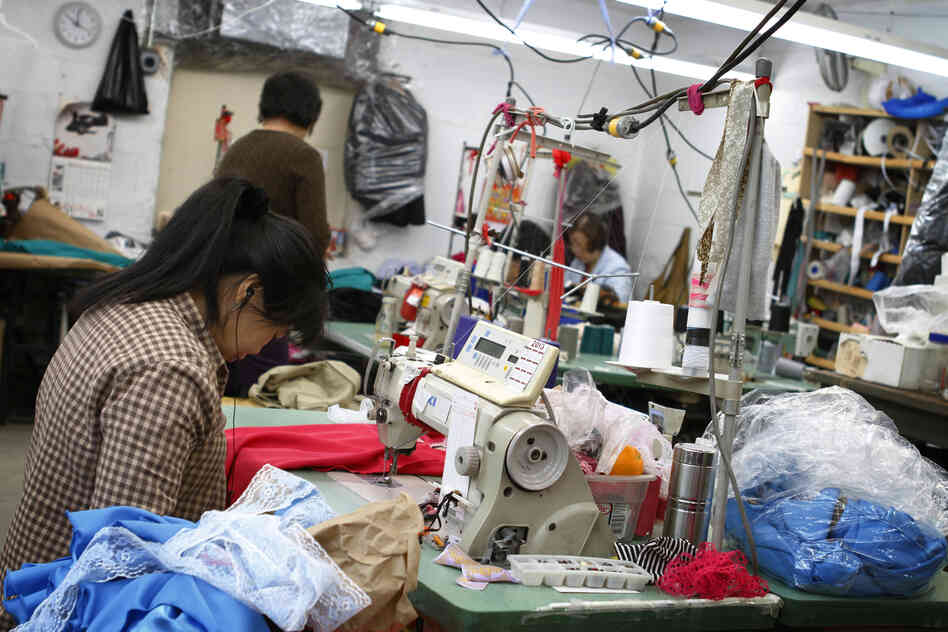 A seamstress works on a garment in the factory Yee contracts to produce her line. While the final product of high-end fashion is crisp and clean, the beginning stages can easily be described as creative chaos.