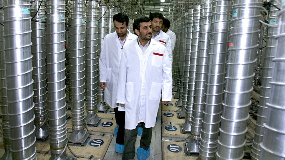 Iranian President Mahmoud Ahmadinejad (center) visits a uranium enrichment facility in Natanz, Iran, in 2008. Enriching uranium requires many fast-spinning centrifuges, arranged in what's called a cascade.