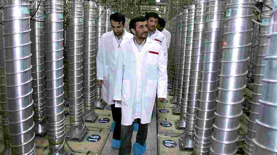 Iranian President Mahmoud Ahmadinejad (center) visits a uranium enrichment facility in Natanz, Iran, in 2008. Enriching uranium requires many fast-spinning centrifuges, arranged in what's called a cascade.