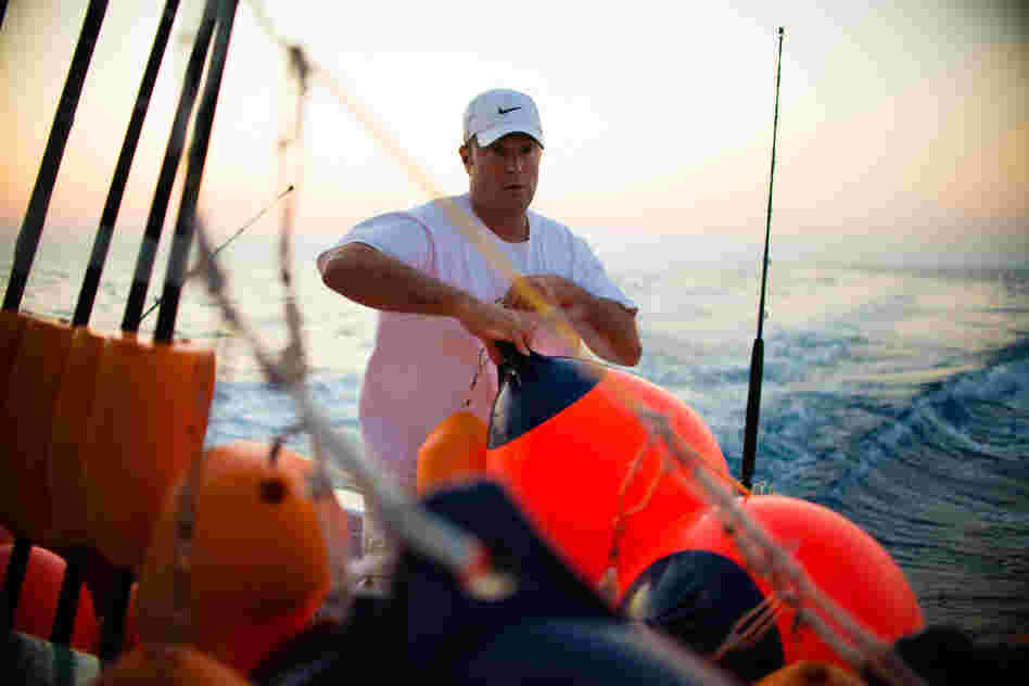 Manganello sets buoys while swordfishing with Palmer. They usually fish with 10-12 buoys that stretch for a mile or two, which have to be repeatedly checked throughout the night for bites.