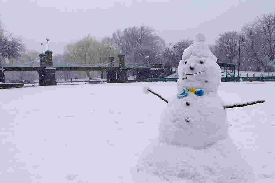 A snowman sits on the duck pond in the Boston Common as snow falls in Boston. 