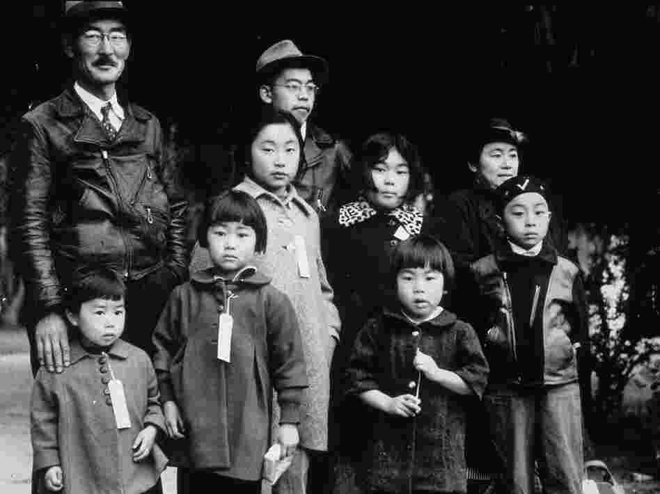 Members of the Japanese-American Mochida family await relocation to an internment camp, in Hayward, Calif., during World War II. In 1942, President Franklin Roosevelt used an executive order to authorize the internment of Americans of Japanese ancestry. In 1988, the U.S. government formally apologized.