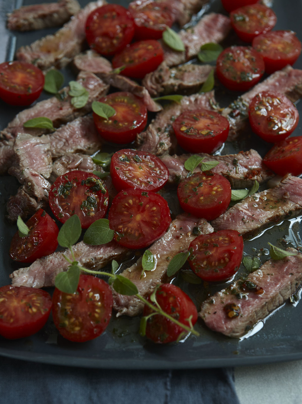 Instead of going to the butcher and asking for a huge hunk of steak cut specially, you can make one supermarket strip steak (it still should be good meat, or don't bother) stretch to feed two of you with no suggestion of scrimping.
