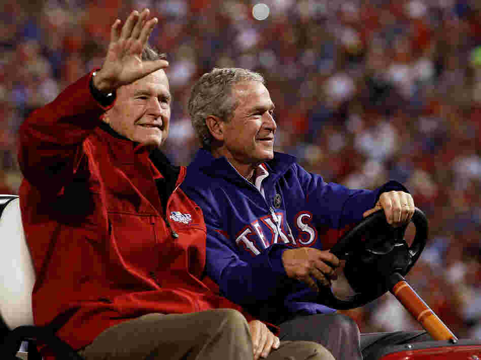 Former presidents George H.W. Bush (left) and George W. Bush at a 2010 World Series game in Arlington, Texas.