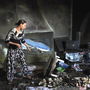 A woman tries to salvage items from a burnt out Sufi shrine outside the Tunisian capital, Tunis, last October. Hard-line Islamists, known as Salafists, have attacked many Sufi shrines in Tunisia recently.