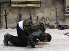 A Syrian rebel prays on a street in the northern city of Aleppo in January. Many Syrians are debating what role Islam should play in Syria if the current secular government is toppled. A Syrian rebel prays on a street in the northern city of Aleppo in January. Many Syrians are debating what role Islam should play in Syria if the current secular government is toppled.