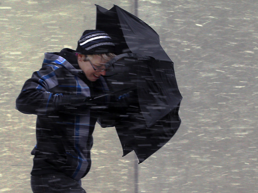 Battling the wind in Boston on Friday, as the storm moved in.