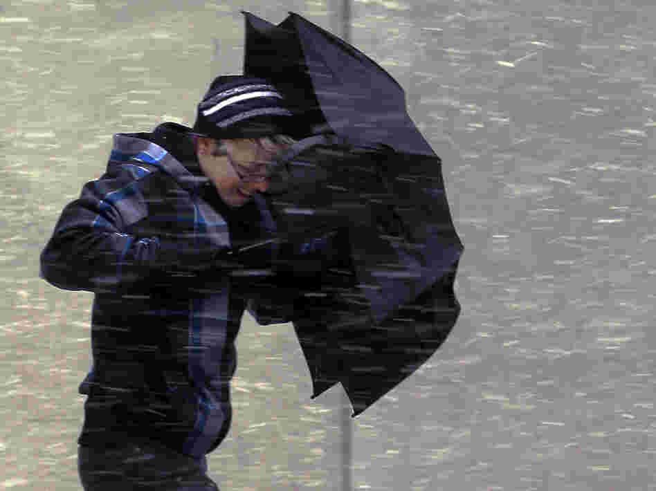Battling the wind in Boston on Friday, as the storm moved in.