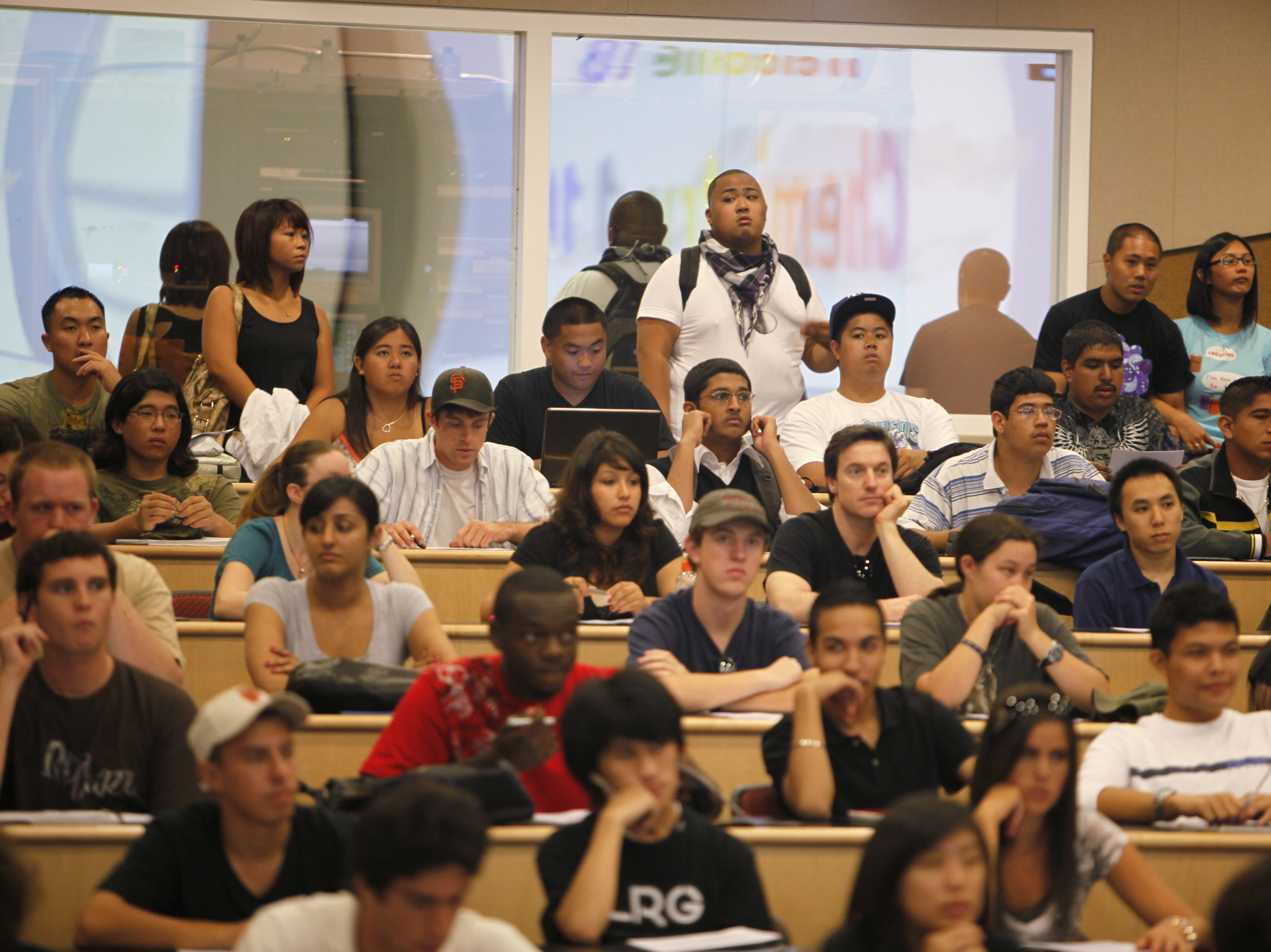 Students stand in the back row of a filled chemistry class at the California State University East Bay in Hayward, Calif., in September  2009. Officials from the Cal State system are seeking new prospective African-American students in church pews.