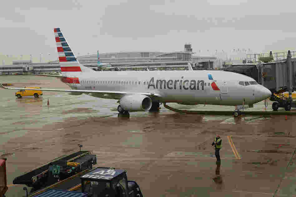 An American Airlines 737-800 aircraft featuring the company's new logo sits at a gate at Chicago's O'Hare International Airport in January. American's merger with US Airways would create the largest U.S. airline.
