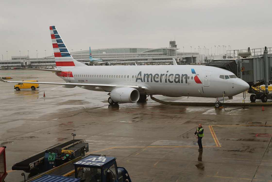 An American Airlines 737-800 aircraft featuring the company's new logo sits at a gate at Chicago's O'Hare International Airport in January. American's merger with US Airways would create the largest U.S. airline.